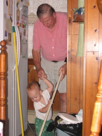 Matthew sweeping with Grandpa